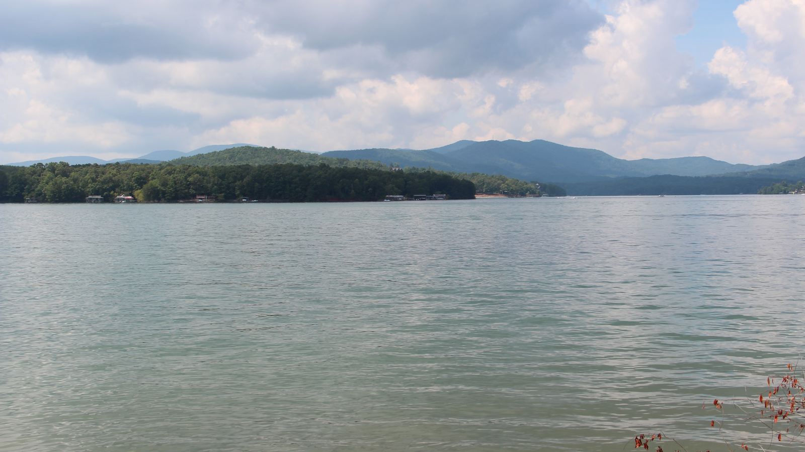 Lake Blue Ridge under a cloudy sky with forested mountains on the far shore, seen from Morganton Point