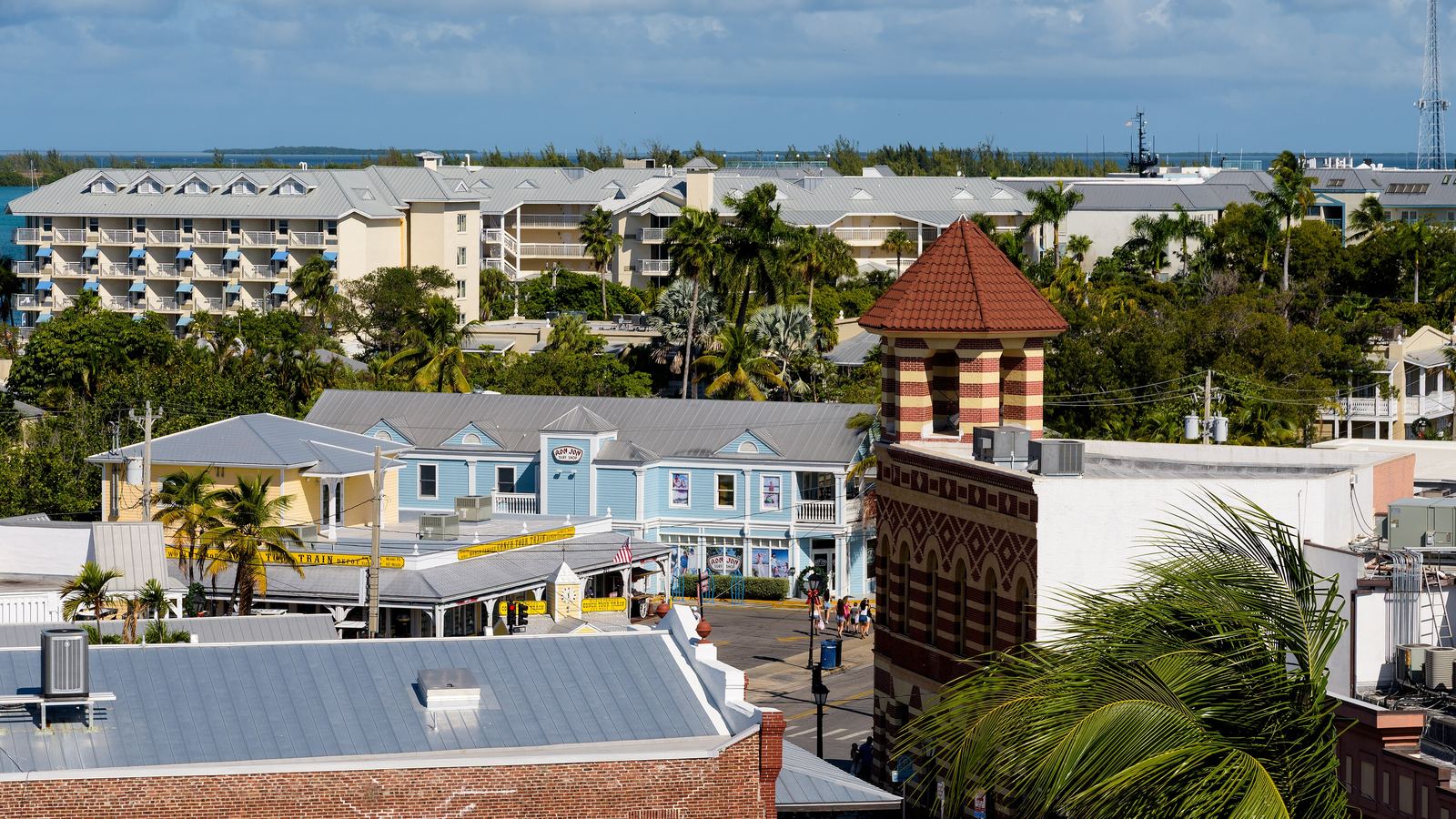 Rooftops, palms and pastel buildings around Front and Duval Street in Key West