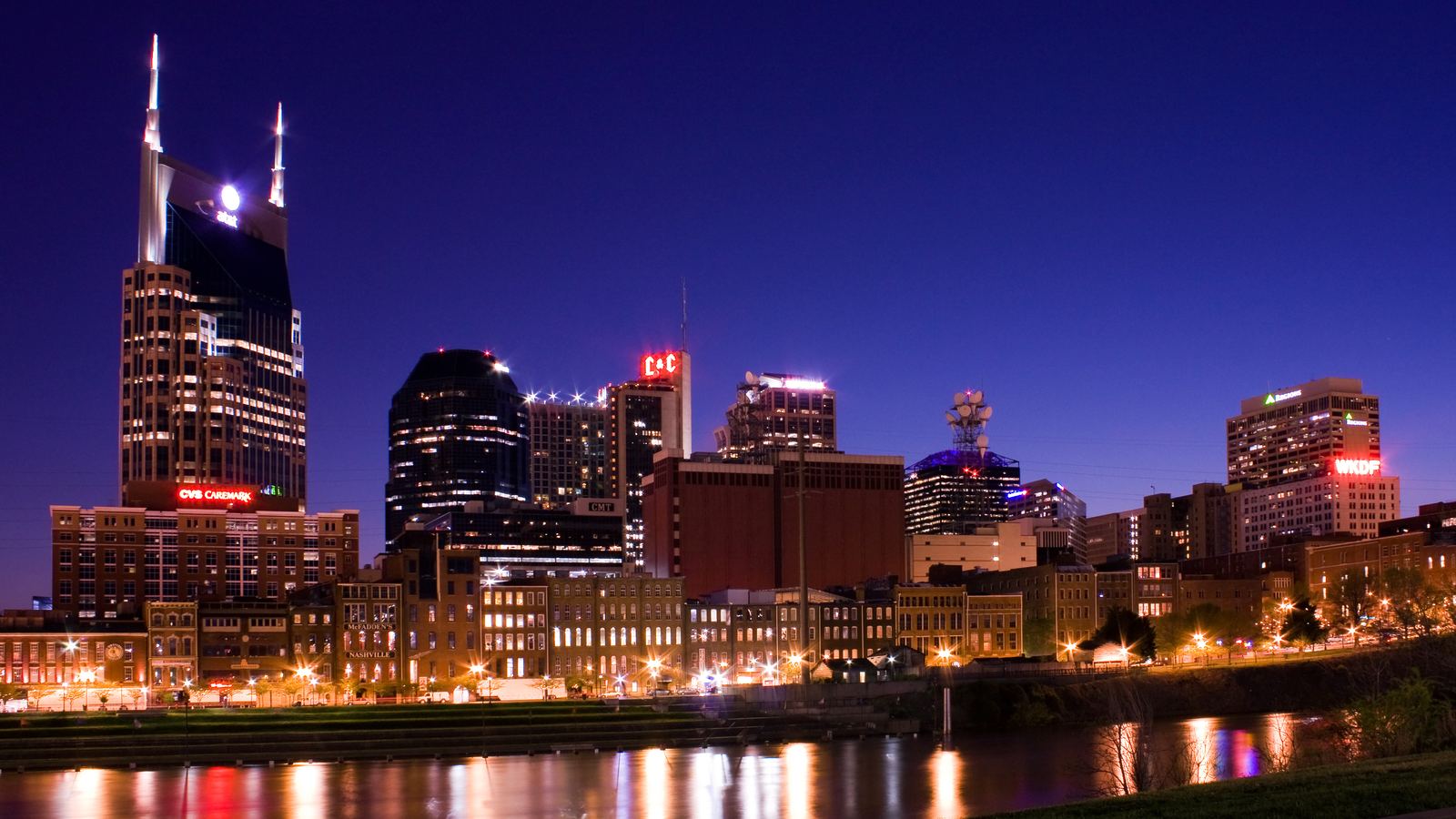 Downtown Nashville lit up at night across the Cumberland River